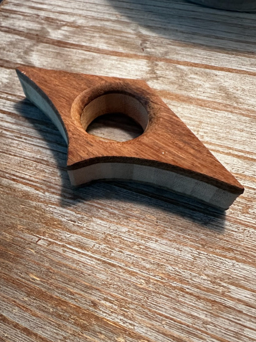 Handmade wooden book page holder with thumb opening holding an open book